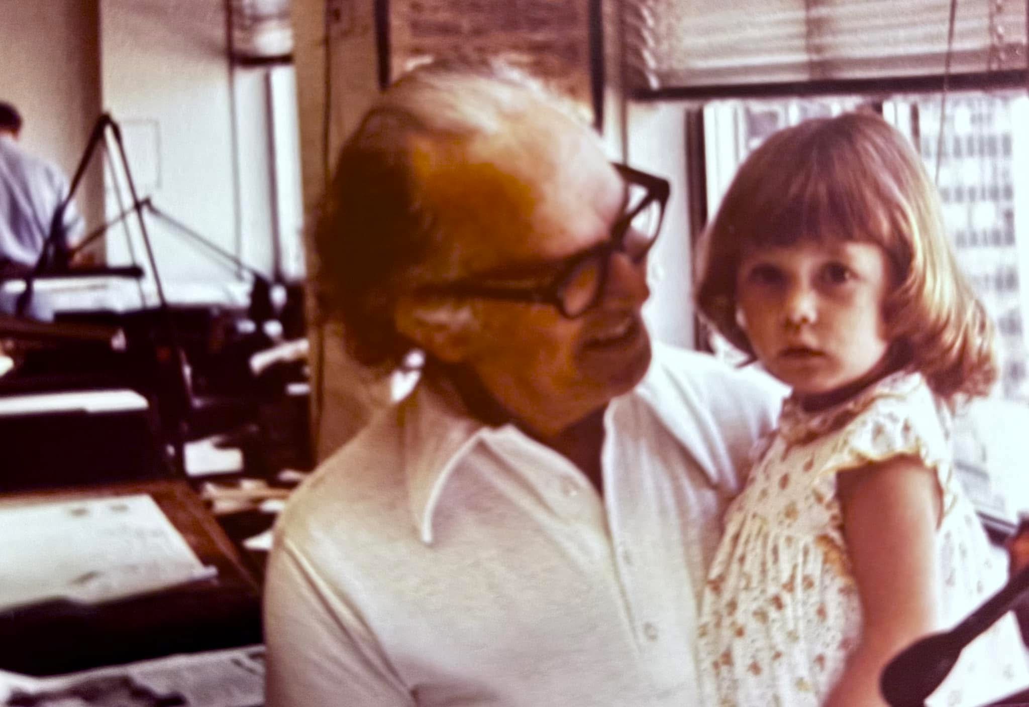 Danielle as a girl with her grandpa at his drafting tables